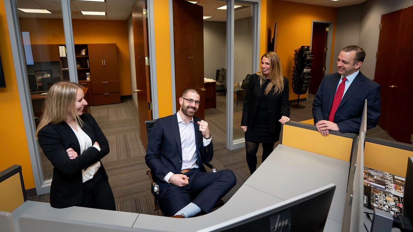 Usherwood employees talking around  a desk