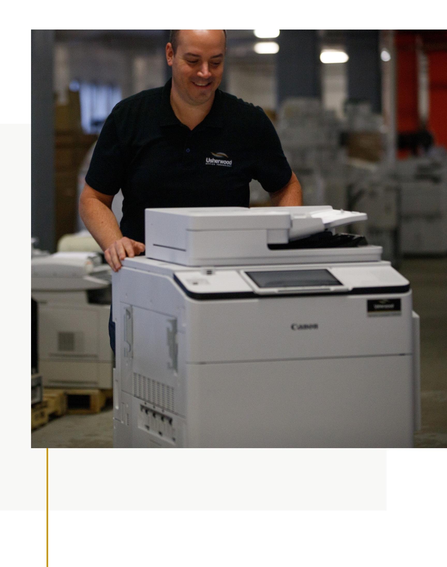 Usherwood employee pushing a copier preparing it for shipment