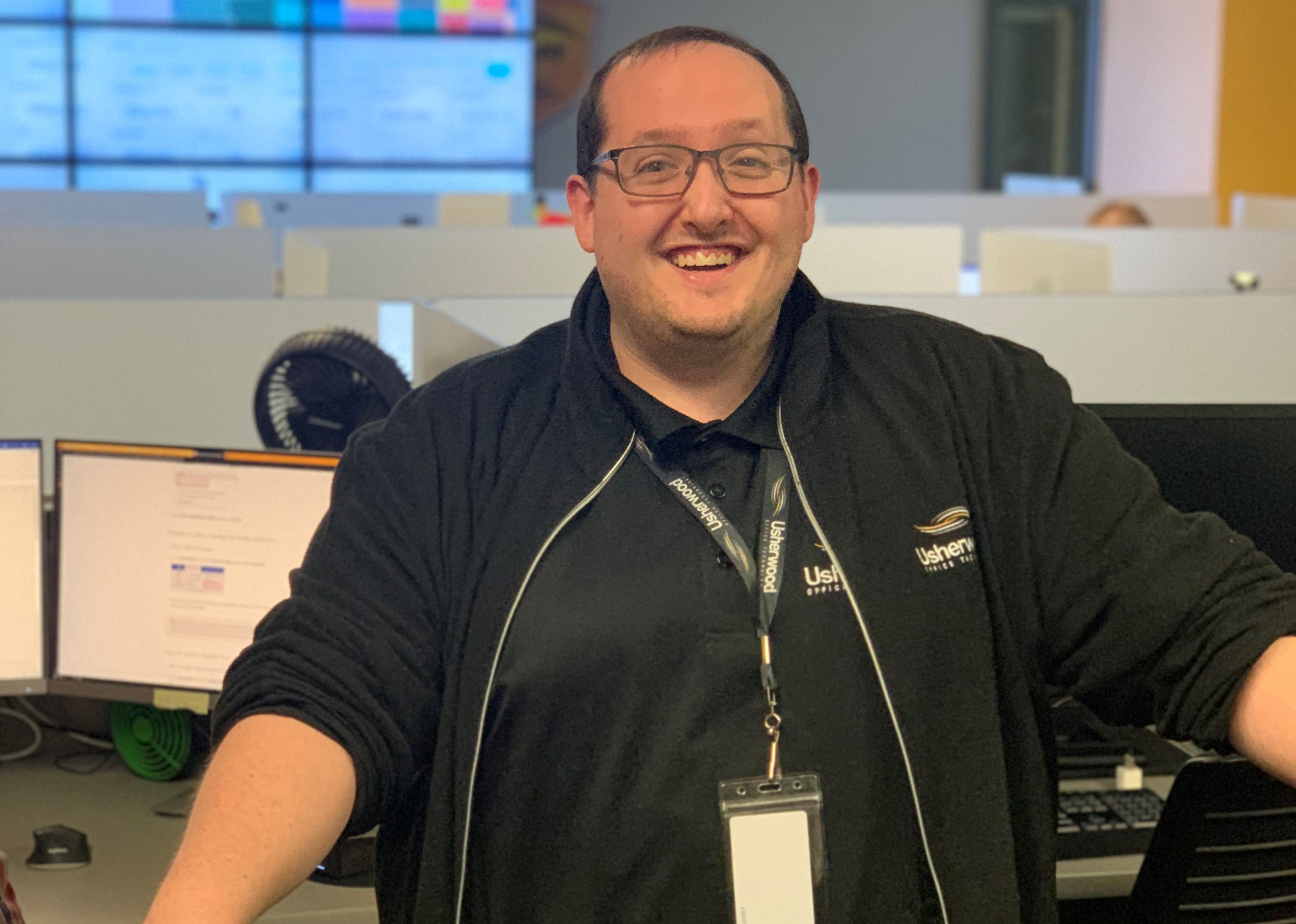 technician smiling in front of Technical Assistance Center 