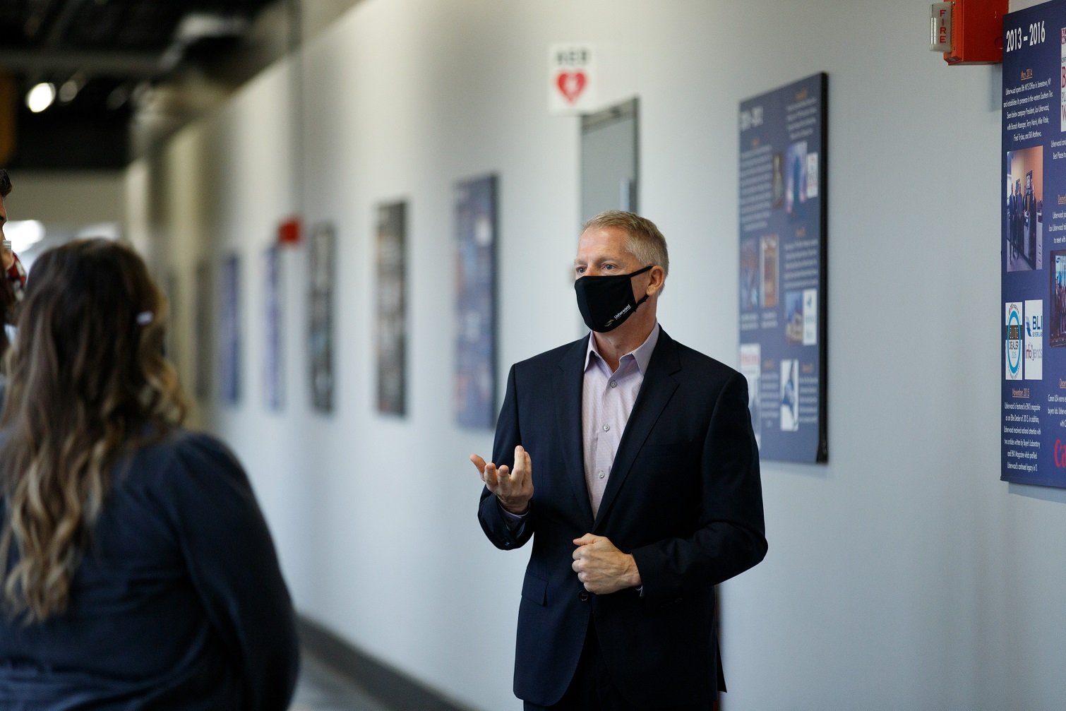 Lou Usherwood with a mask giving the Usherwood Way tour to new employees