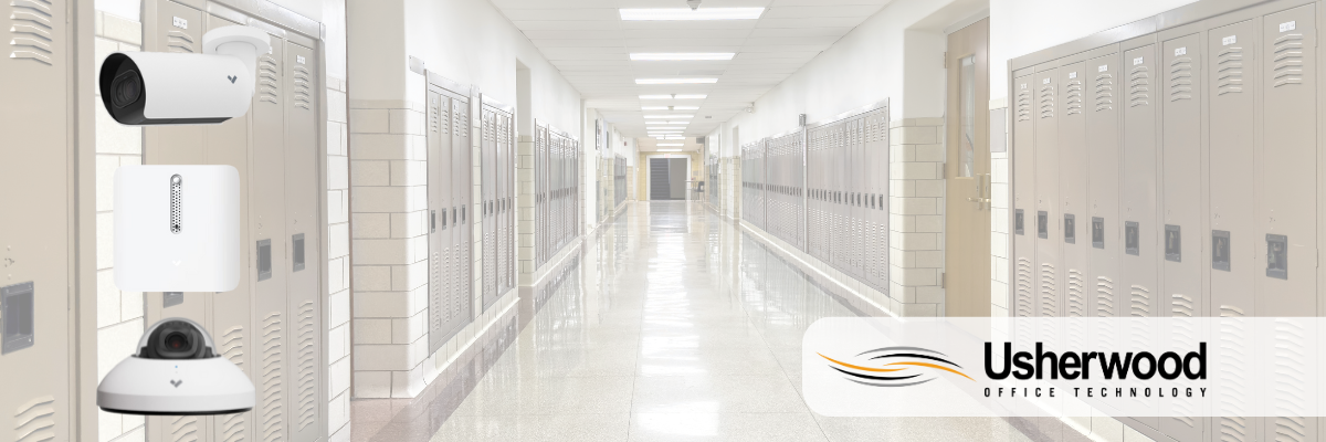 School hallway with security cameras on the left side and usherwood logo on the right
