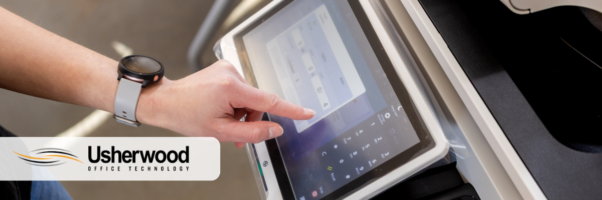 persons hand pressing button on printer- Production Printer vs. Wide Format Printer: What’s the Difference?